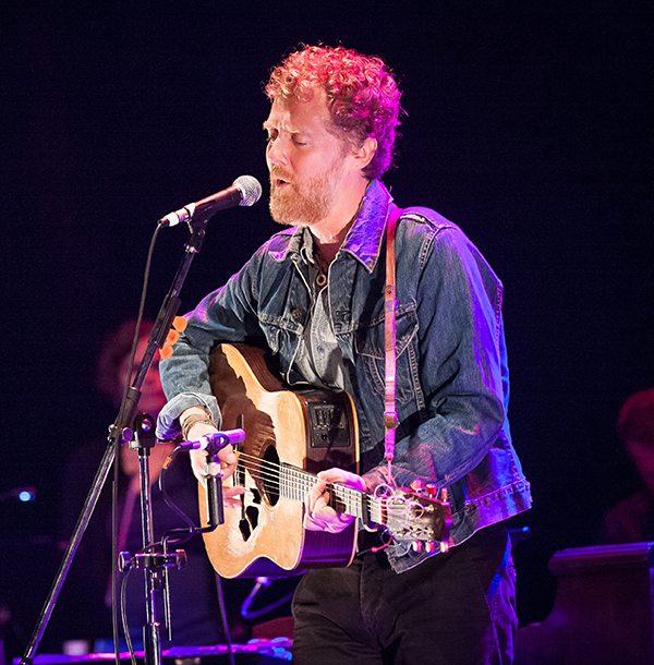 Glen Hansard playing guitar on stage